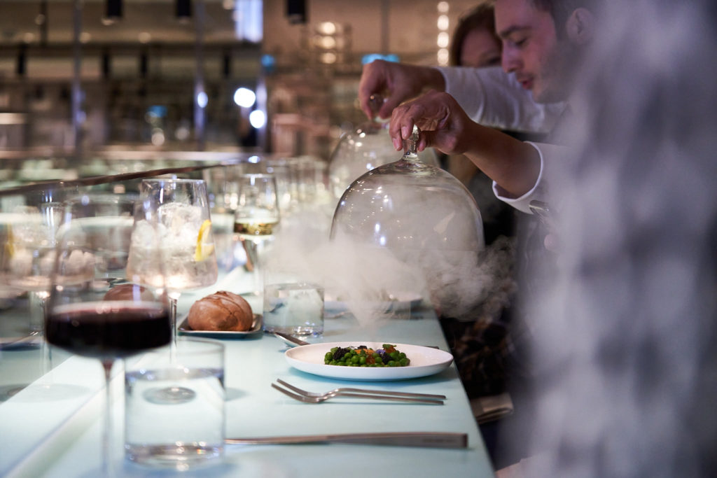 Steam rises out of a globe as part of the iconic interactive food presentation at Test Kitchen.